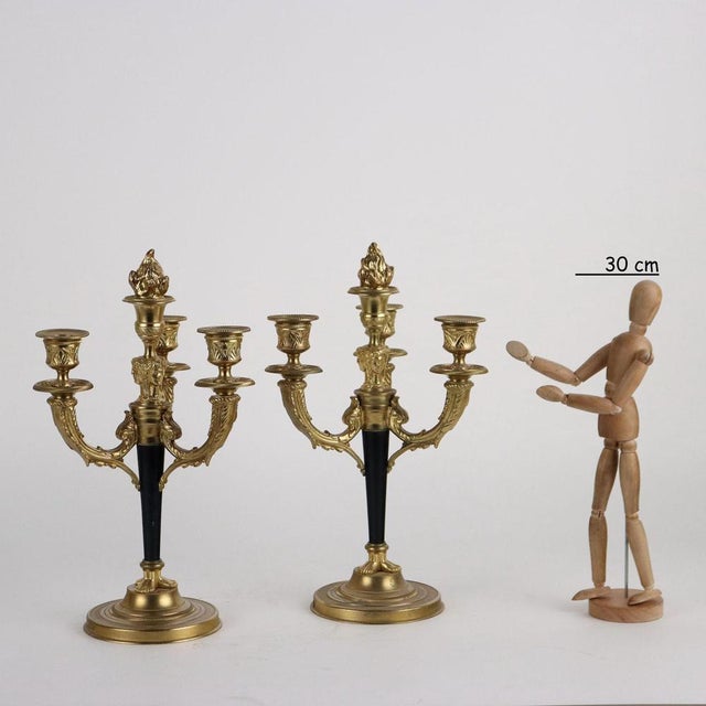 Pair of Albert Marionnet candlesticks, in gilded and painted bronze, with three arms, with neoclassical decoration. The...