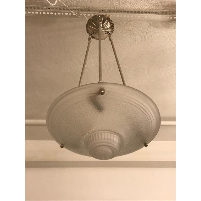 Stunning French Art Deco chandelier by Muller Frères Luneville. With beautiful clear frosted glass bowl with geometric...