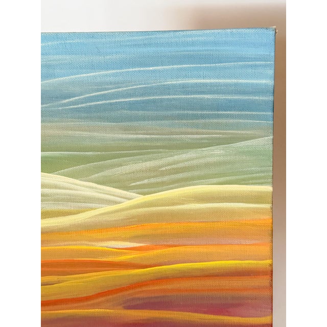 A more contemporary abstract approach to a landscape painting, the artist has painted swathes of colors from the rainbow...