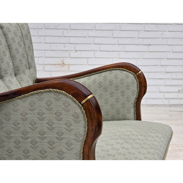 1960s, Danish armchair. Light blue furniture fabric, beech wood armrests and legs with brass plugs. Sofa was reupholstered...