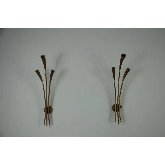 This elegant pair of brass wall lamps was designed by renowned italian designer oscar torlasco in the 1960s. Featuring an...