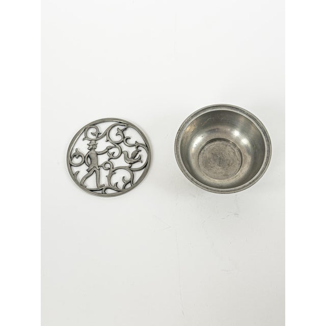 The piece carries the unmistakable poetic quality of Edvin Ollers’ decorative language, where Swedish pewter craftsmanship...