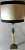 Empire style table lamp in the shape of a column; the body is in refined Afyon Miele marble from Carrara; the Corinthian...