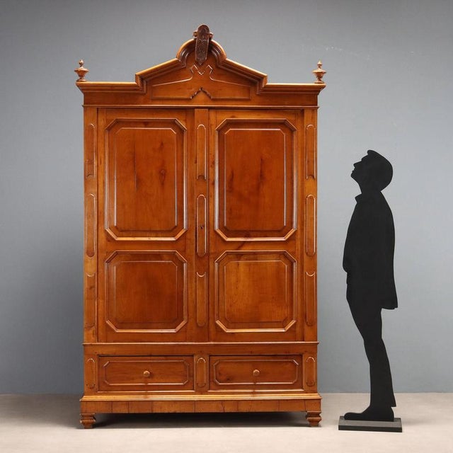 Umbertino cherry wardrobe. Front with a pair of two-part paneled doors and a pair of drawers in the base, two-part paneled...