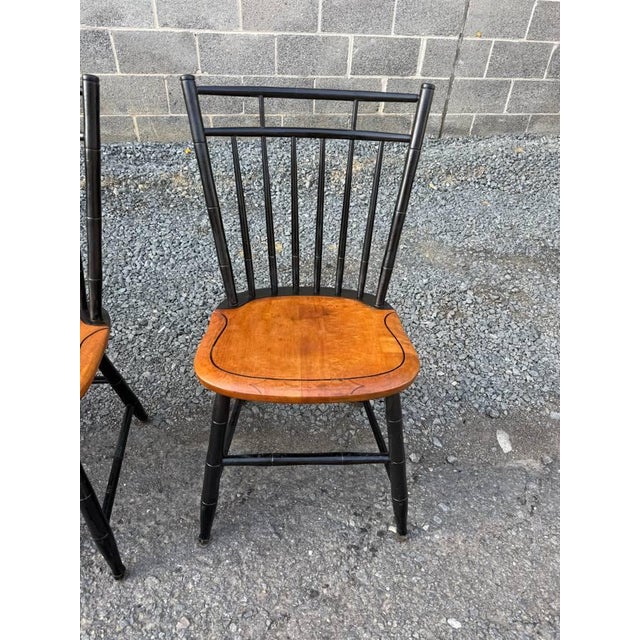 Set of 4 signed Hitchcock birdcage side chairs Due to age and use, Hitchcock marks are fading and hard to see Splay legs,...