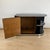 Small asymmetrical Art Deco Lowboard from France around 1930. Black, high-gloss polished piano lacquer on wood. Door with...