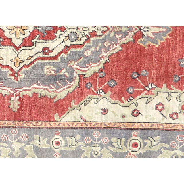 A vintage Turkish Oushak measuring 5'4" x 11'2", hand-woven with wool on wool foundation. This piece displays the region's...