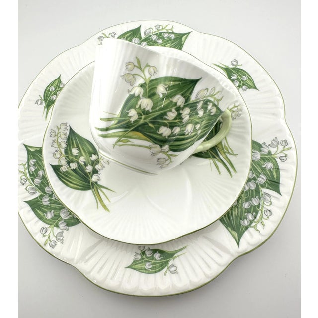 This lovely Shelley set, Lily of the Valley pattern, with white flowers and green foliage, includes a cup, saucer, and...