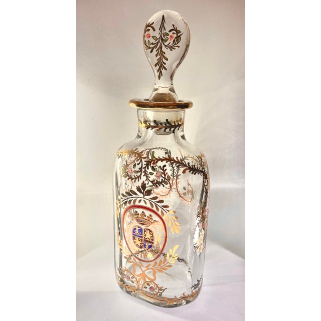 Superb crystal perfume bottle with top, hand decorated with flowers surrounding an heraldic blason. H 9" (circa 1850) This...