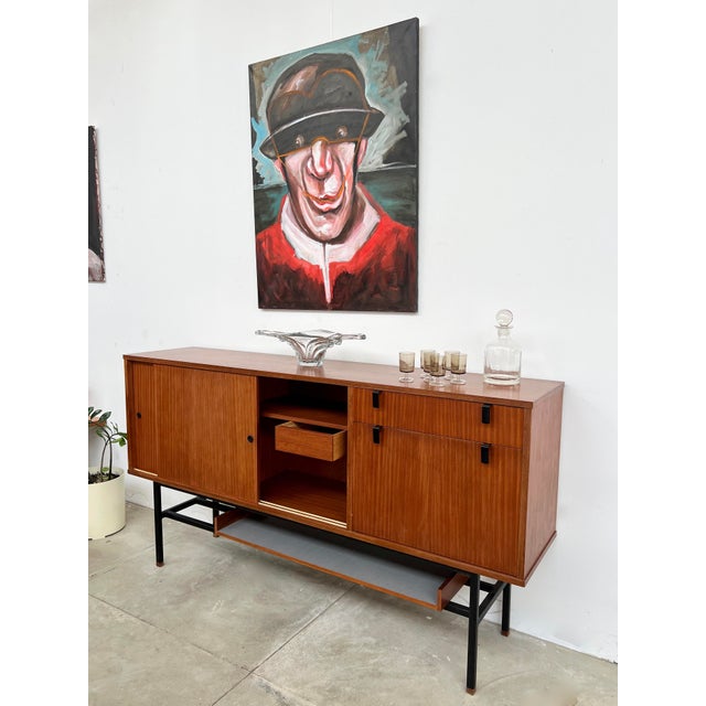 Sideboard designed by alain richard, produced by caminelle, france, 1960s. Deep, nuanced teak veneer on a remarkably...