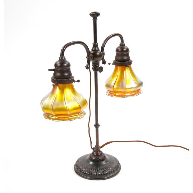 This exquisite Tiffany Studios Bronze & Art Glass Lamp is a remarkable piece of early 20th-century craftsmanship,...