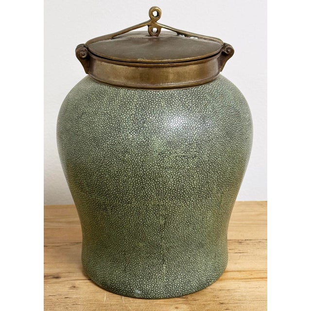Tozai Home faux shagreen temple jar with brass lid. Rich gray green finish to body of jar with sculptured rim and lid....