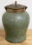 Tozai Home faux shagreen temple jar with brass lid. Rich gray green finish to body of jar with sculptured rim and lid....