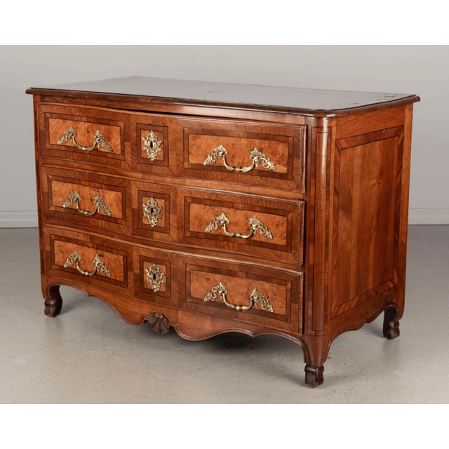 An 18th century French Louis XIV style commode from Grenoble with fine marquetry inlay of cherry, walnut and mahogany....