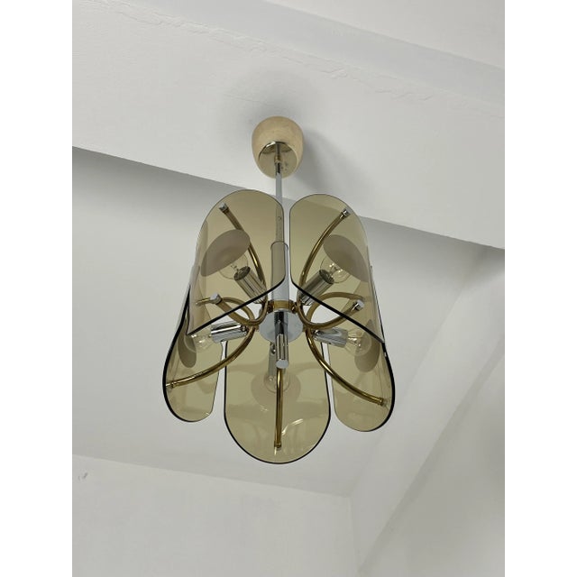 Five-light amber Murano glass chandelier, 1970s Chrome-plated metal frame, E14 bulbs. Glass intact, good condition....