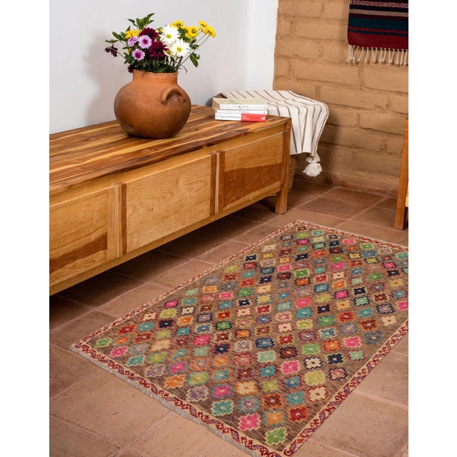 This stunning hand-knotted Afghan Balouchi rug is a captivating addition to any decor. Crafted by skilled artisans, it...