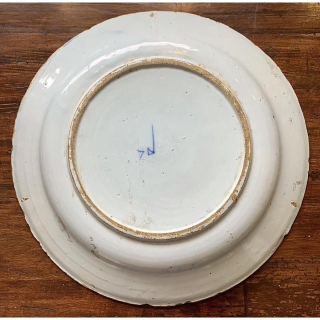 Eighteenth century Dutch Delft Charger, mark ofDe Porseleine Byl on the underside, the upper surface decorated with large...