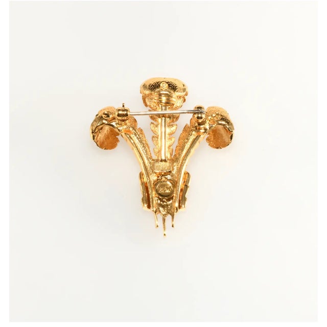 Prince of Wales feather and crown brooch embellished with clear rhinestones and gold plated metal. This piece is modeled...