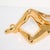 This Mid-Century gold-plated ceramic sculpture, depicting a reclining woman, is a captivating work of American design...
