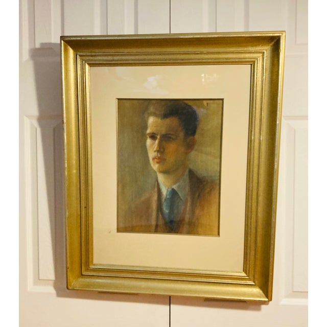 Classic portrait of a young adult man wearing suit and tie done in soft pastel colors framed in wood silver gilt frame
