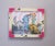 This mixed-media acrylic on plexiglas artwork features a whimsical scene of a woman interacting with playful cats,...