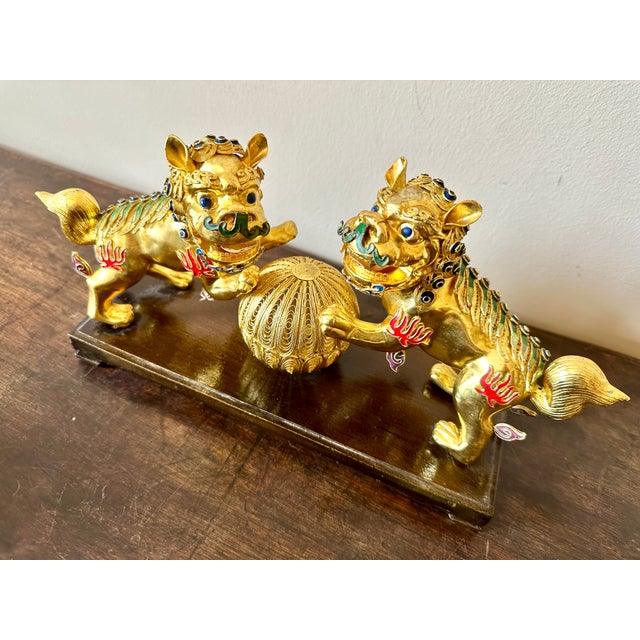 Vintage gold gilt metal and cloisonné two Chinese foo dogs.