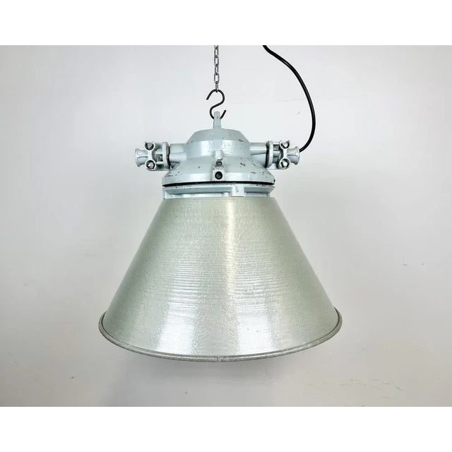 Industrial factory light manufactured by Elektrosvit in former Czechoslovakia during the 1970s. It features a cast...