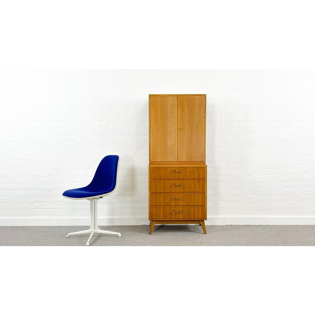 Two-part bar cabinet, consisting of a chest of drawers with 4 drawers and an attached bar cabinet. Stamped on the back...