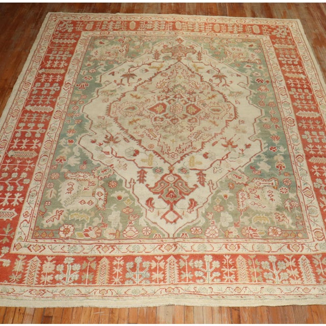 An early 20th century room size antique Turkish oushak rug Measures: 10'3'' x 13'.
