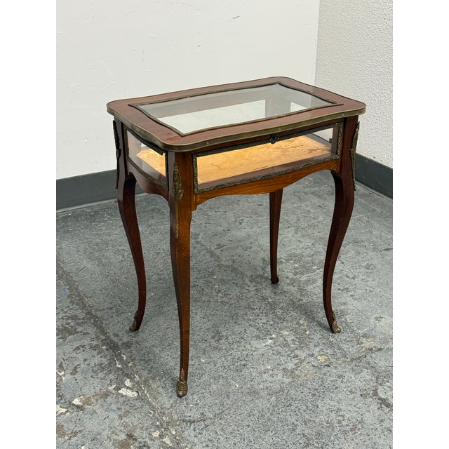 Design Plus Gallery presents a Vintage Louis XV Style Glass Top Vitrine Display Table. This distinctive table is...