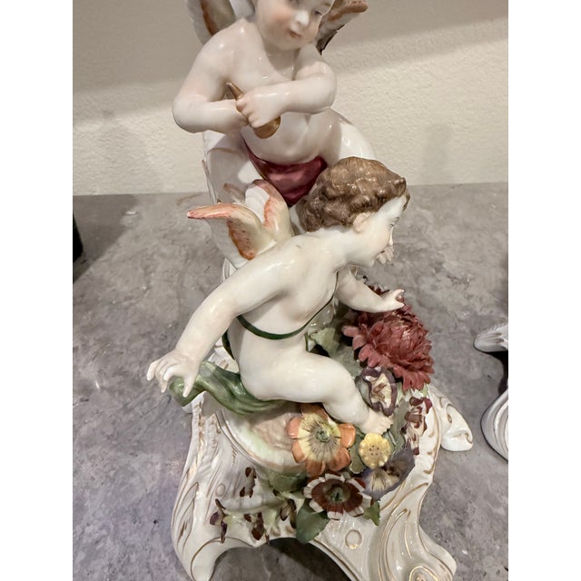 The Von Schierholz Handmalerei Dresden Cherub Putti flower Candle Holders are a pair of beautifully crafted porcelain...