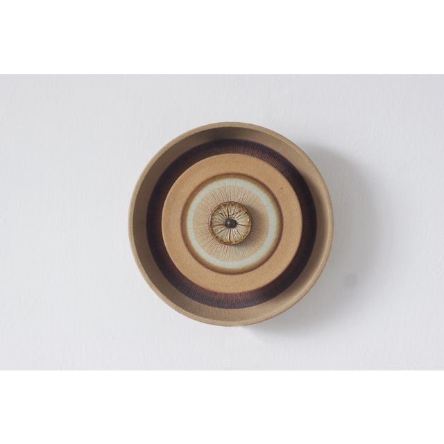 A ceramic wall sconce designed by danish designer noomi backhausen for the søholm stentøj pottery on the island of...