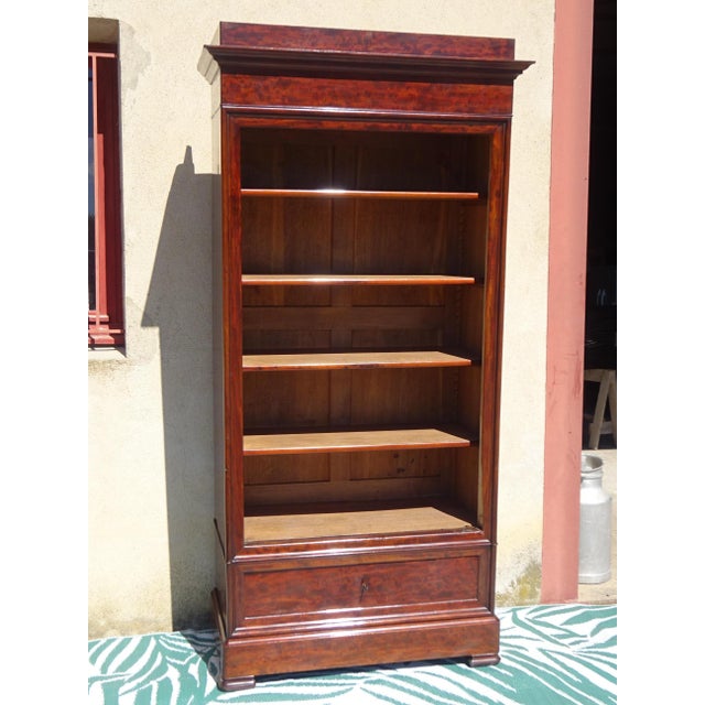 Antique solid wood bookcase with a removable pediment and adjustable shelves. The front and sides are mahogany, with...