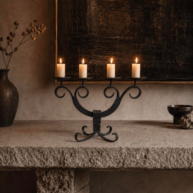 An exceptional mid-to-late 20th-century vintage hand-forged wrought iron 4-arm candelabra, masterfully crafted in Germany....