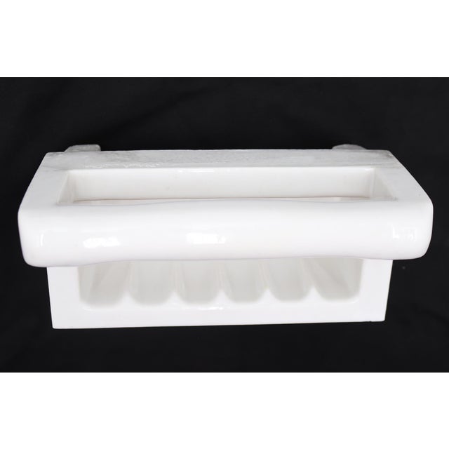 Flush mount rectangular bathroom soap dish made of white porcelain over ceramic with a handle. Made by Willette Corp....