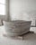 Cova Stone Bath – Sculpted Solid Silver Travertine Bathtub: The Cova Stone Bath is a monolithic bathtub carved from a...