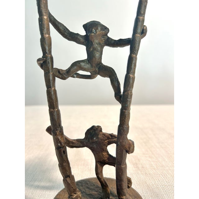 Mid-century inspired candlestick holder by Andrea by Sadek, featuring sculptural cast iron construction with playful...