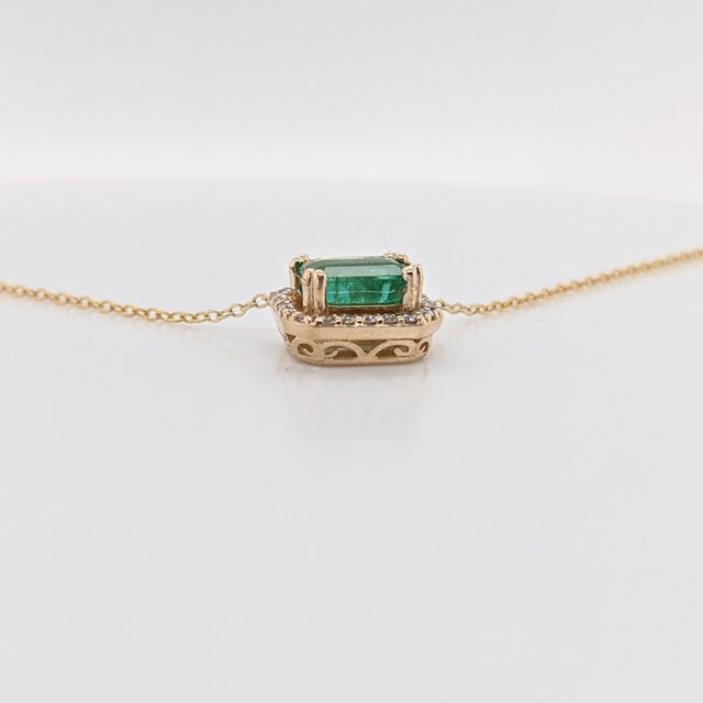 This beautiful pendant necklace features a 0.84 carat emerald cut Emerald gemstone with a halo of natural earth mined...