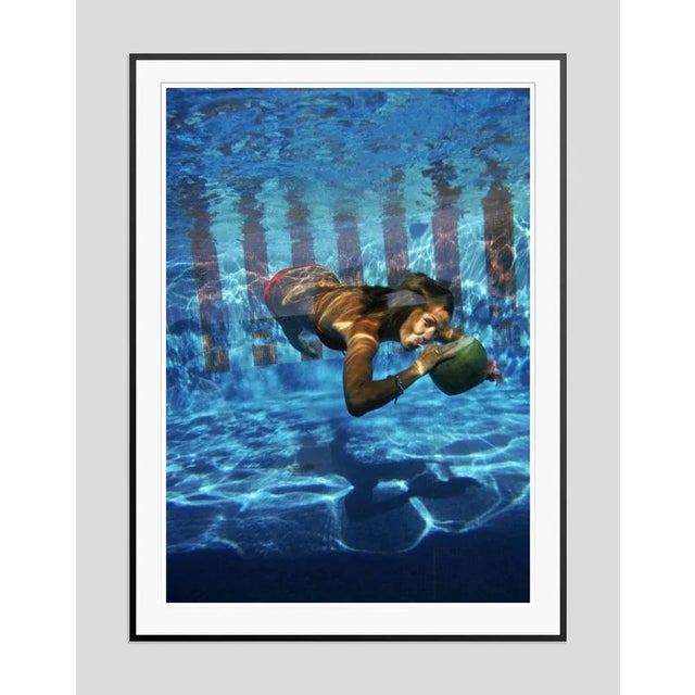 Underwater drink' by slim aarons open edition a woman drinking from a coconut underwater in the pool at las brisas hotel...
