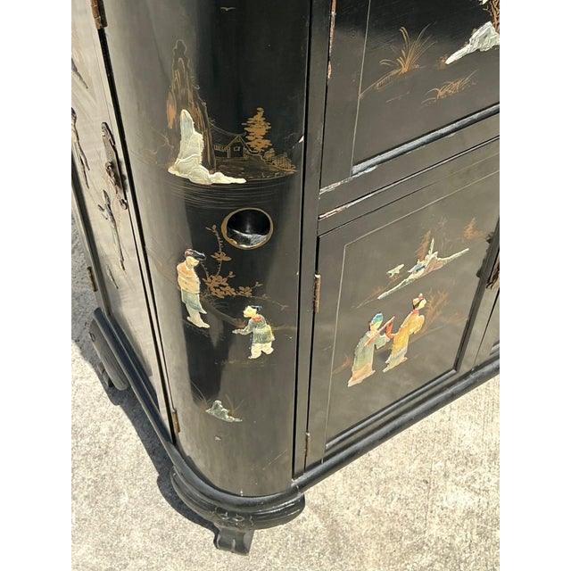This exquisite mid-century dry bar is a masterful example of Chinoiserie artistry, featuring a deep black lacquer finish...