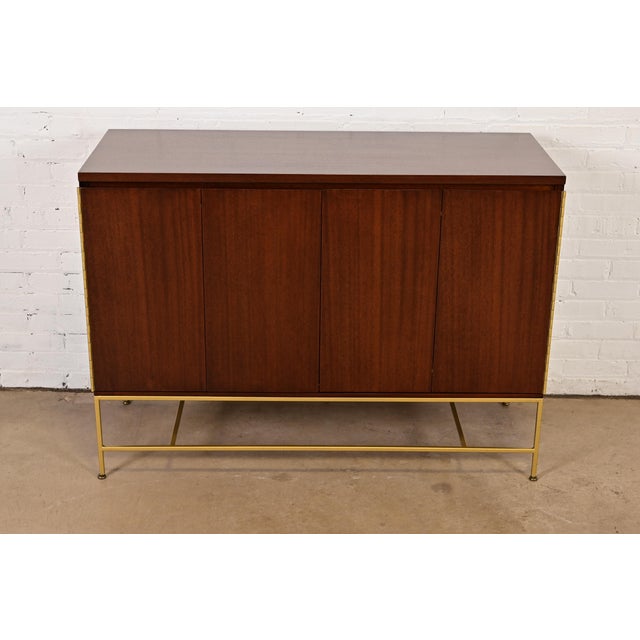 An outstanding Mid-Century Modern sideboard, credenza, dresser, or bar cabinet By Paul McCobb for Directional and produced...