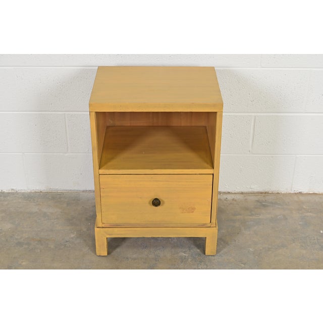 A sleek and stylish Mid-Century Modern or Hollywood Regency single-drawer nightstand By T.H. Robsjohn-Gibbings for...