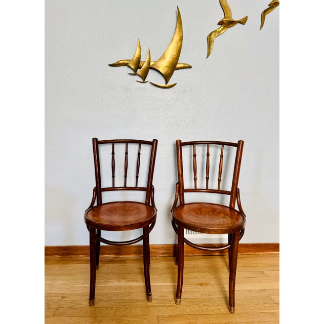 Pair of antique bentwood café chairs with marquetry iris seats, embossed "Made in Romania for B.M. Lawrence Company, San...
