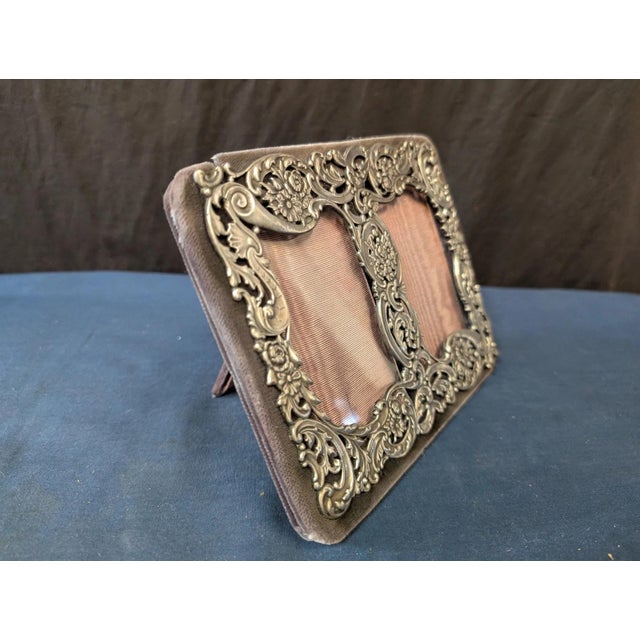 This vintage early twenteeth century sterling silver photoframe was designed by Herham. Displayed is a stylish yet...