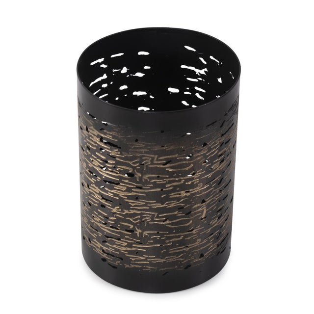 This vase boasts a matte black exterior with delicate light golden etchings adorning its surface, intricately woven like...