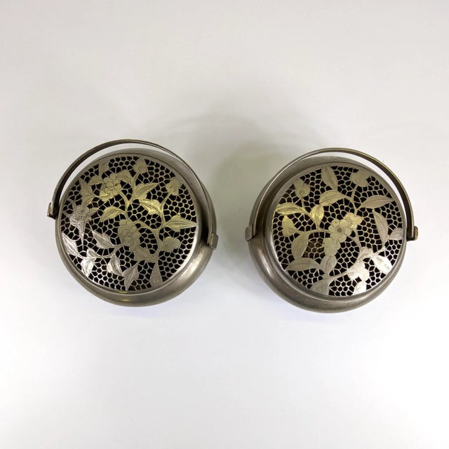 A pair of white brass hand warmers. The lace metal work was hand carved chisel out. This can be used as a potpourri container