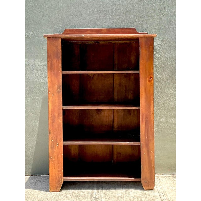 This vintage handcrafted solid wood shelving unit captures the enduring appeal of rustic craftsmanship with its honest...