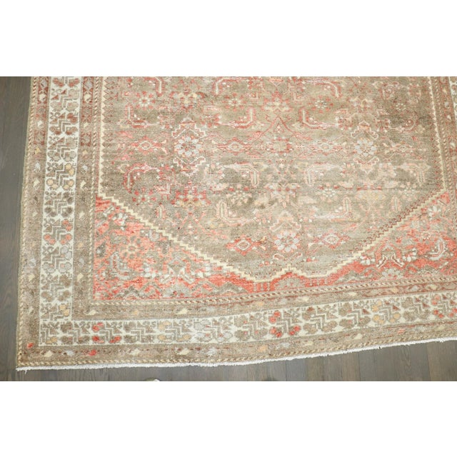 an early 20th Persian Malayer intermediate rug with a cappuchino field and accents in soft red