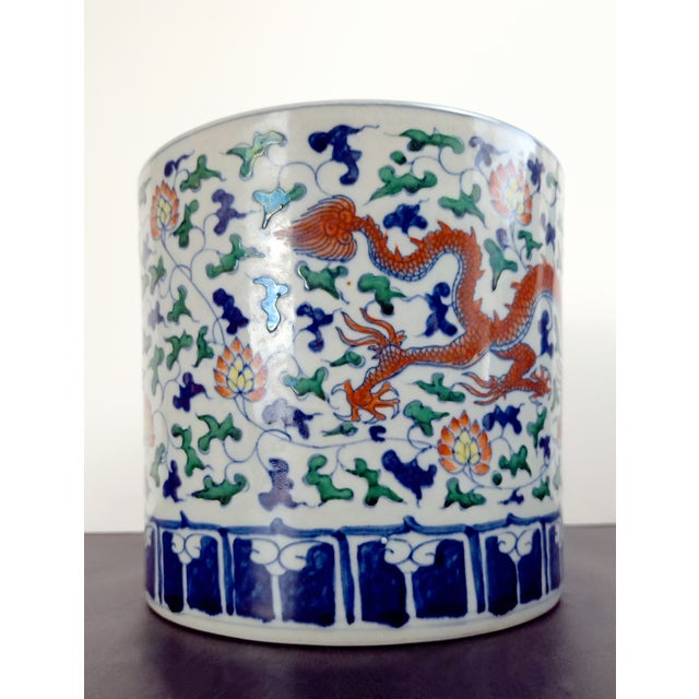 Chinese porcelain red dragon bitong, a finely formed, straight-sided brushpot with a polychrome glazed exterior over a...