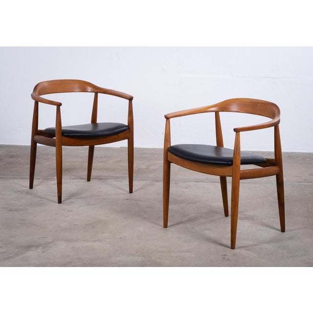 Elegant pair of Danish armchairs designed by Illum Wikkelsø for Niels Eilersen in the 1950s. Crafted from elm, the chairs...